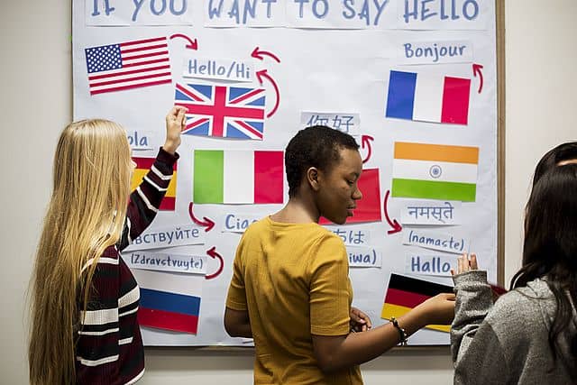 high school students working international flags board